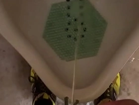 Male pees in urinal after workout